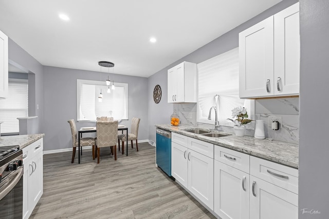 kitchen with light hardwood / wood-style flooring, stainless steel appliances, white cabinetry, and sink