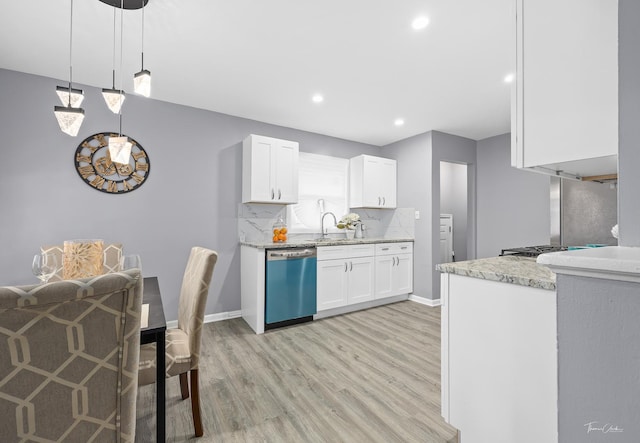 kitchen featuring pendant lighting, white cabinets, light wood-type flooring, tasteful backsplash, and stainless steel appliances