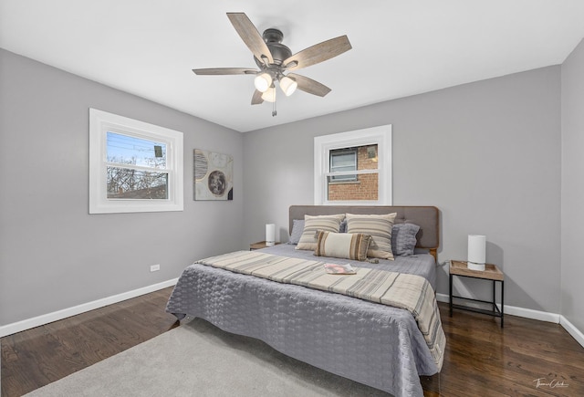 bedroom with dark hardwood / wood-style flooring and ceiling fan