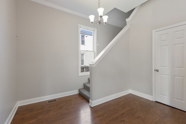 interior space featuring ornamental molding, a chandelier, and hardwood / wood-style floors