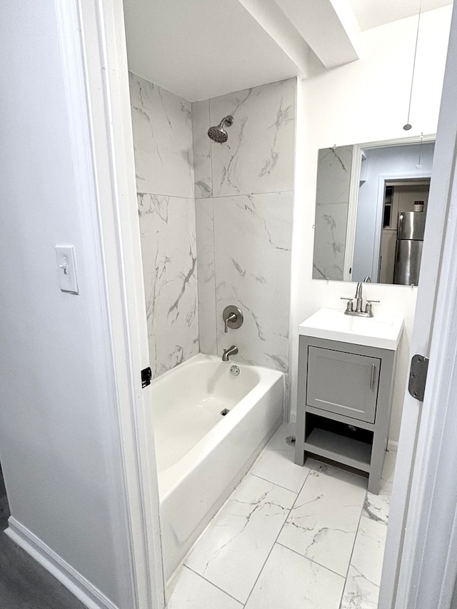 bathroom with tiled shower / bath combo and vanity