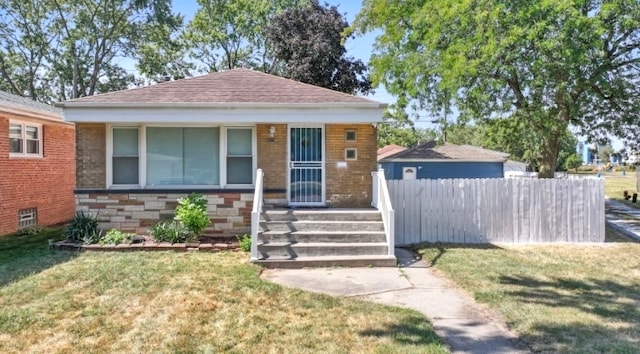 bungalow-style home featuring a front yard