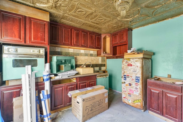 kitchen featuring tasteful backsplash and oven