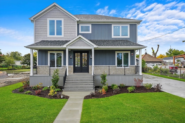 view of front of house with a front yard and a porch