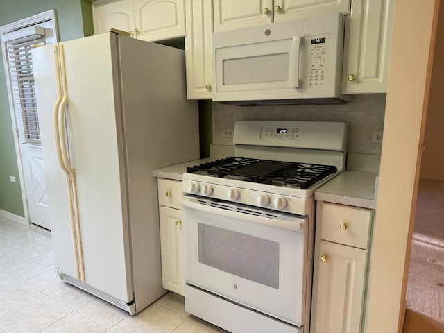 kitchen with white appliances, decorative backsplash, and light tile patterned floors