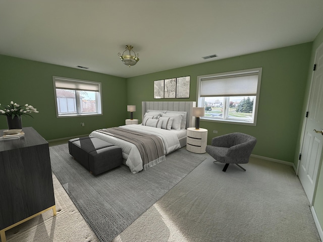 carpeted bedroom featuring multiple windows