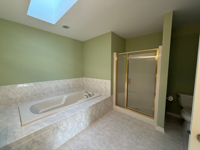 bathroom featuring a skylight, toilet, plus walk in shower, and tile patterned floors