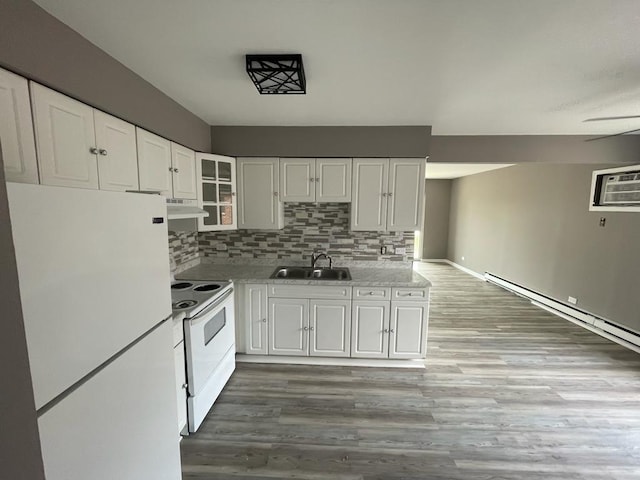 kitchen featuring white cabinets, exhaust hood, dark hardwood / wood-style flooring, sink, and white appliances