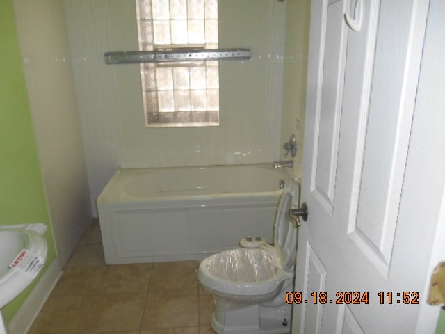 bathroom featuring toilet and tile patterned flooring