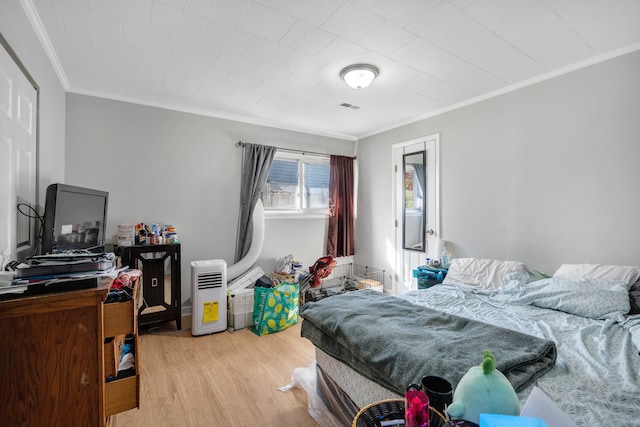 bedroom featuring crown molding and wood-type flooring