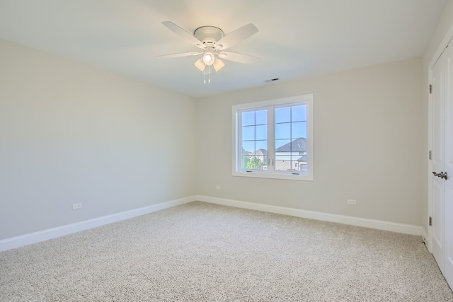 spare room featuring carpet flooring and ceiling fan