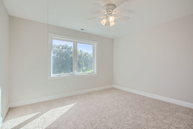 carpeted empty room featuring ceiling fan