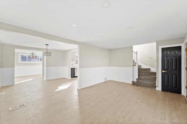 unfurnished living room with light wood-type flooring