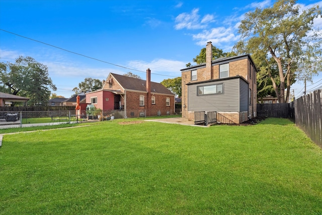 rear view of house with a yard