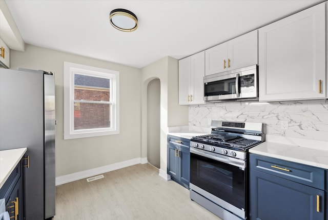 kitchen with white cabinetry, appliances with stainless steel finishes, and blue cabinets