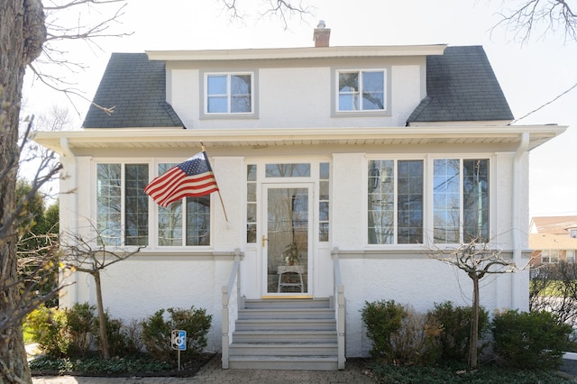 view of front of home with a sunroom