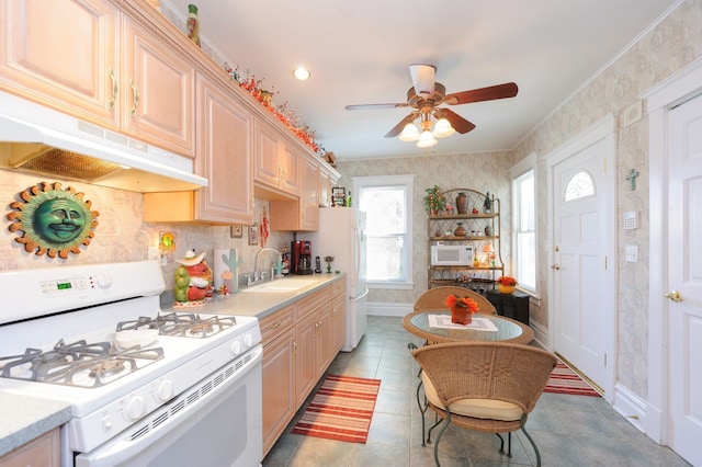 kitchen with light brown cabinets, white appliances, ceiling fan, and light tile patterned flooring