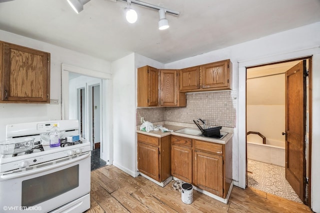 3545 Oak Ave, Brookfield, IL 60513 - kitchen with brown cabinets, light countertops, white range with gas stovetop, and light wood-type flooring