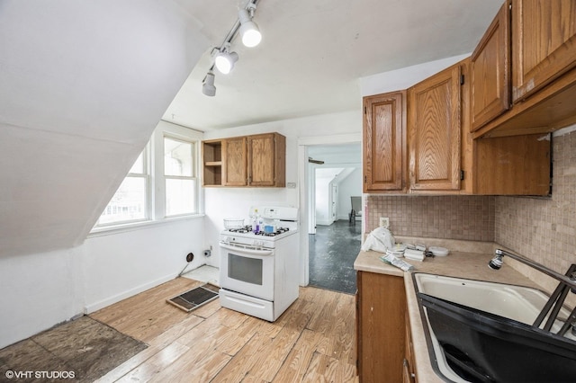 3545 Oak Ave, Brookfield, IL 60513 - kitchen featuring light wood finished floors, white gas range oven, brown cabinets, and a sink
