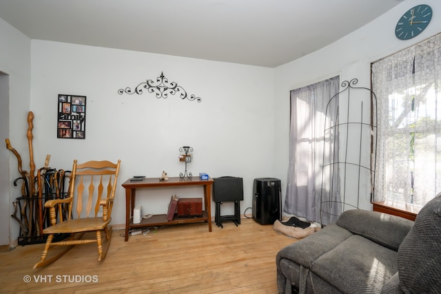 sitting room with wood-type flooring