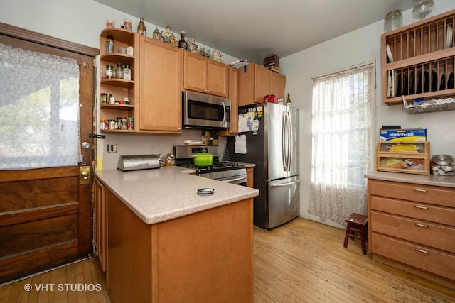 3545 Oak Ave, Brookfield, IL 60513 - kitchen featuring a peninsula, brown cabinets, open shelves, light wood finished floors, and appliances with stainless steel finishes