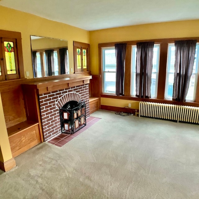 carpeted living room with a fireplace and radiator