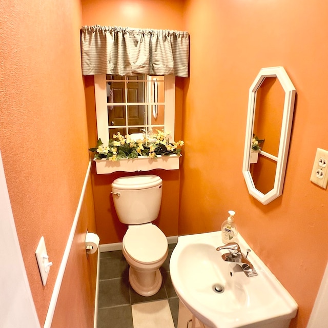 bathroom with sink, tile patterned flooring, and toilet