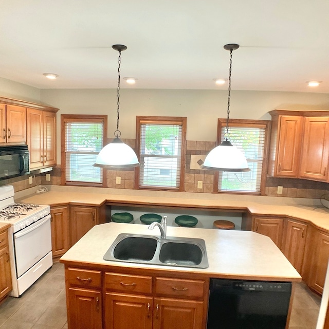 kitchen with black appliances, plenty of natural light, and tasteful backsplash