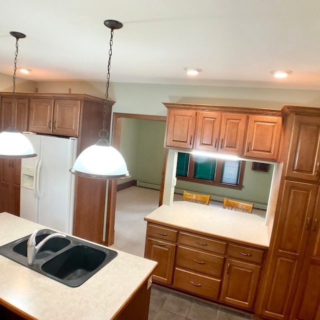 kitchen with dark tile patterned flooring, hanging light fixtures, sink, a kitchen island, and white fridge with ice dispenser