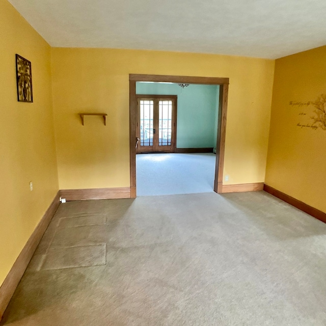 carpeted empty room with french doors