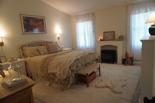 carpeted bedroom featuring multiple windows and vaulted ceiling