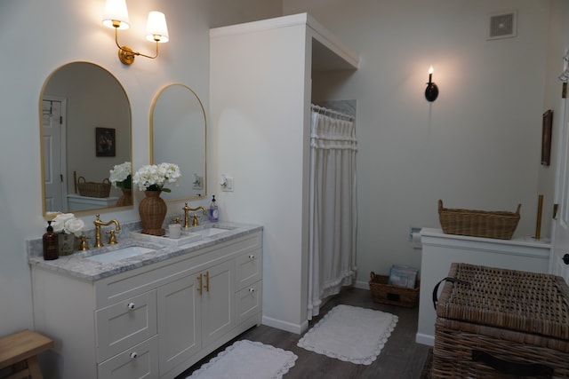 bathroom featuring vanity and hardwood / wood-style floors