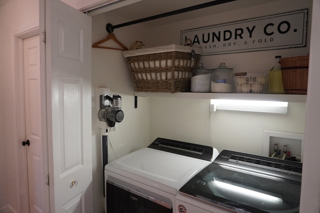 washroom featuring washer and clothes dryer