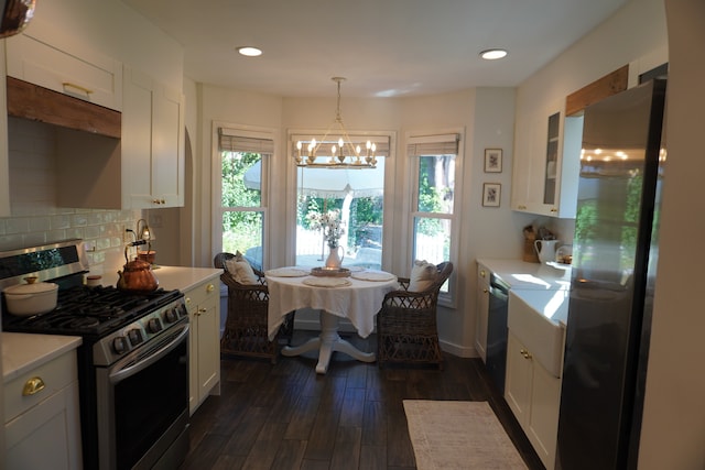 kitchen featuring stainless steel appliances, white cabinets, and dark hardwood / wood-style floors