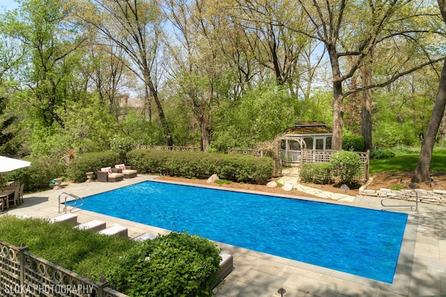 view of swimming pool featuring a gazebo and a patio area