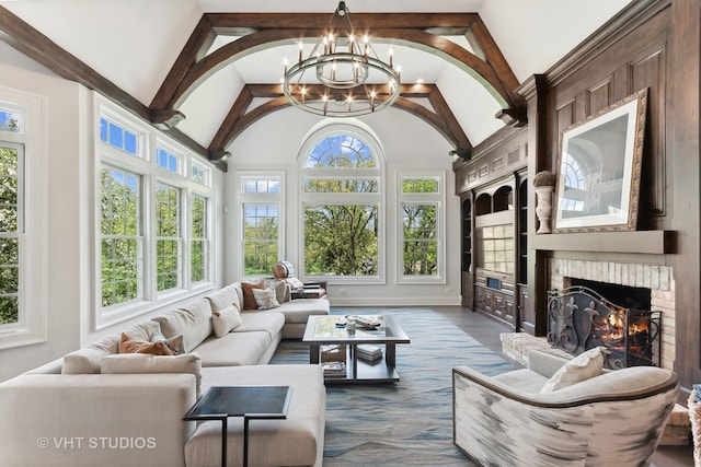 sunroom with a brick fireplace, a healthy amount of sunlight, and vaulted ceiling