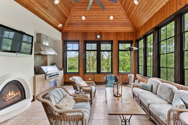 sunroom featuring ceiling fan, wood ceiling, and vaulted ceiling