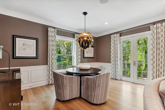 dining room featuring plenty of natural light, french doors, crown molding, and light hardwood / wood-style flooring