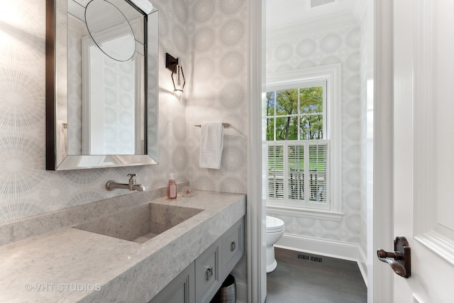 bathroom featuring ornamental molding, hardwood / wood-style flooring, vanity, and toilet