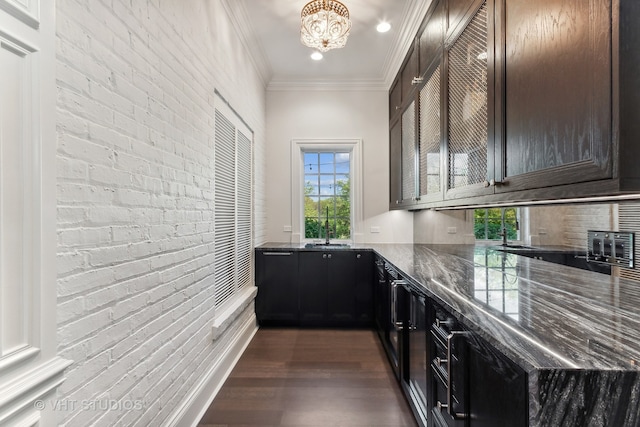 bar featuring dark hardwood / wood-style floors, crown molding, brick wall, and dark stone countertops