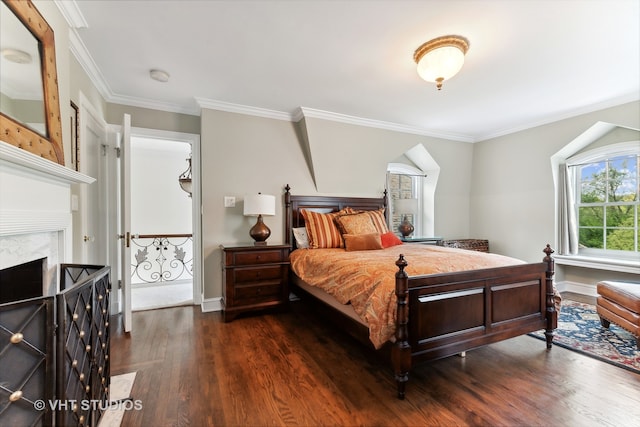 bedroom with ornamental molding, a high end fireplace, and dark hardwood / wood-style floors