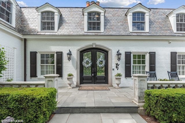 entrance to property featuring french doors and covered porch