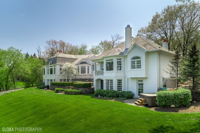 back of house with a lawn