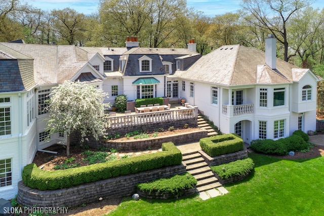 back of house with a lawn