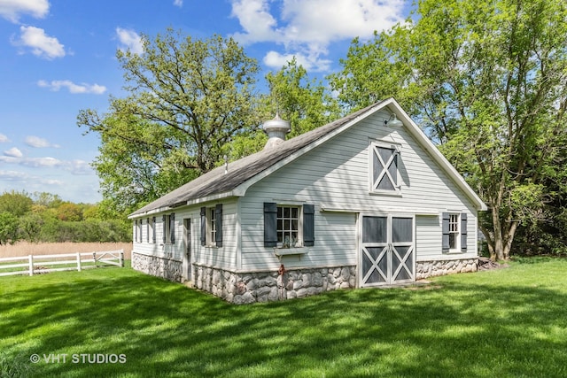 back of house with a lawn