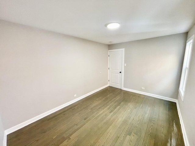 spare room with dark hardwood / wood-style floors