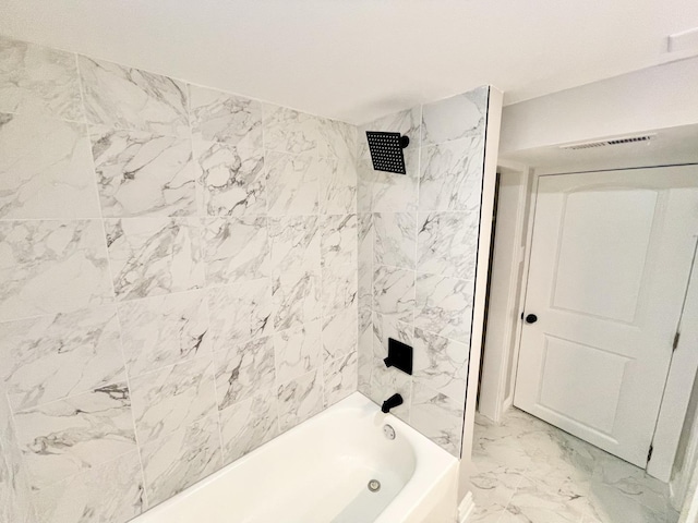 bathroom featuring tiled shower / bath combo