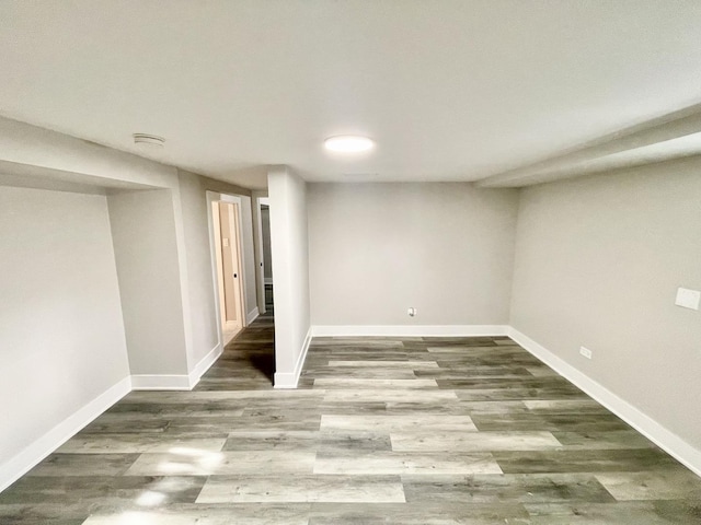 basement with dark hardwood / wood-style floors