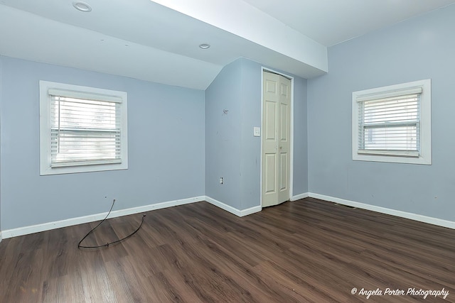 bonus room featuring plenty of natural light, dark hardwood / wood-style floors, and vaulted ceiling