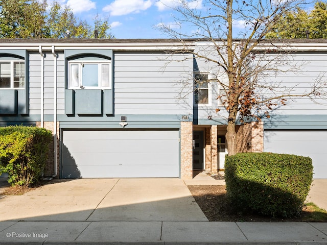 townhome / multi-family property featuring a garage